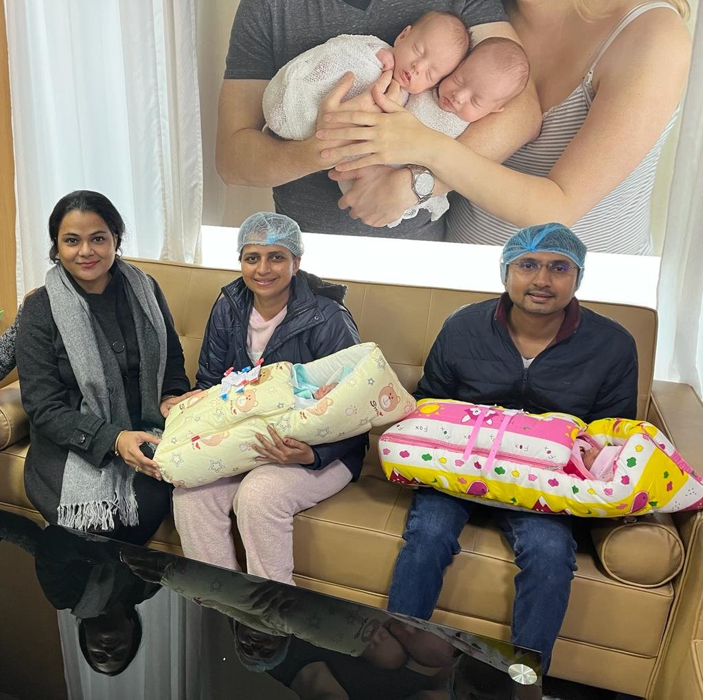 Parents holding newborn twins