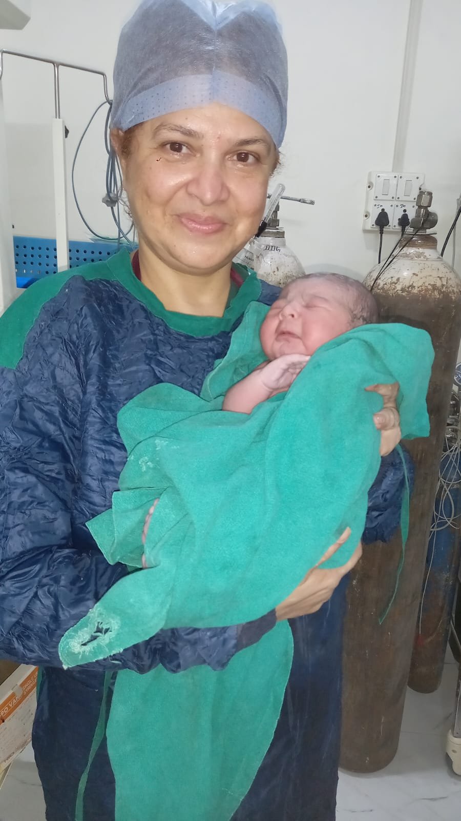 Smiling nurse with newborn
